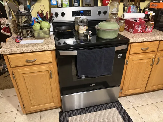 a stove top oven sitting inside of a kitchen