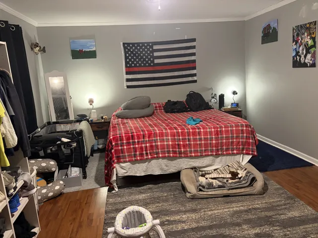 a bedroom with a bed and a window