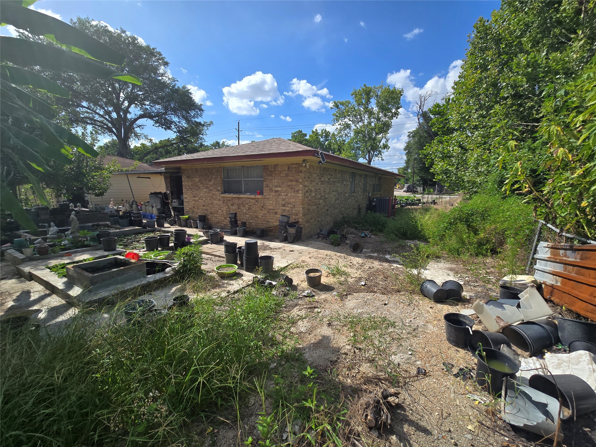 6713 Breen Drive Houston, TX 77086 - Photo 13 of 21 a backyard of a house with table and chairs and a fire pit