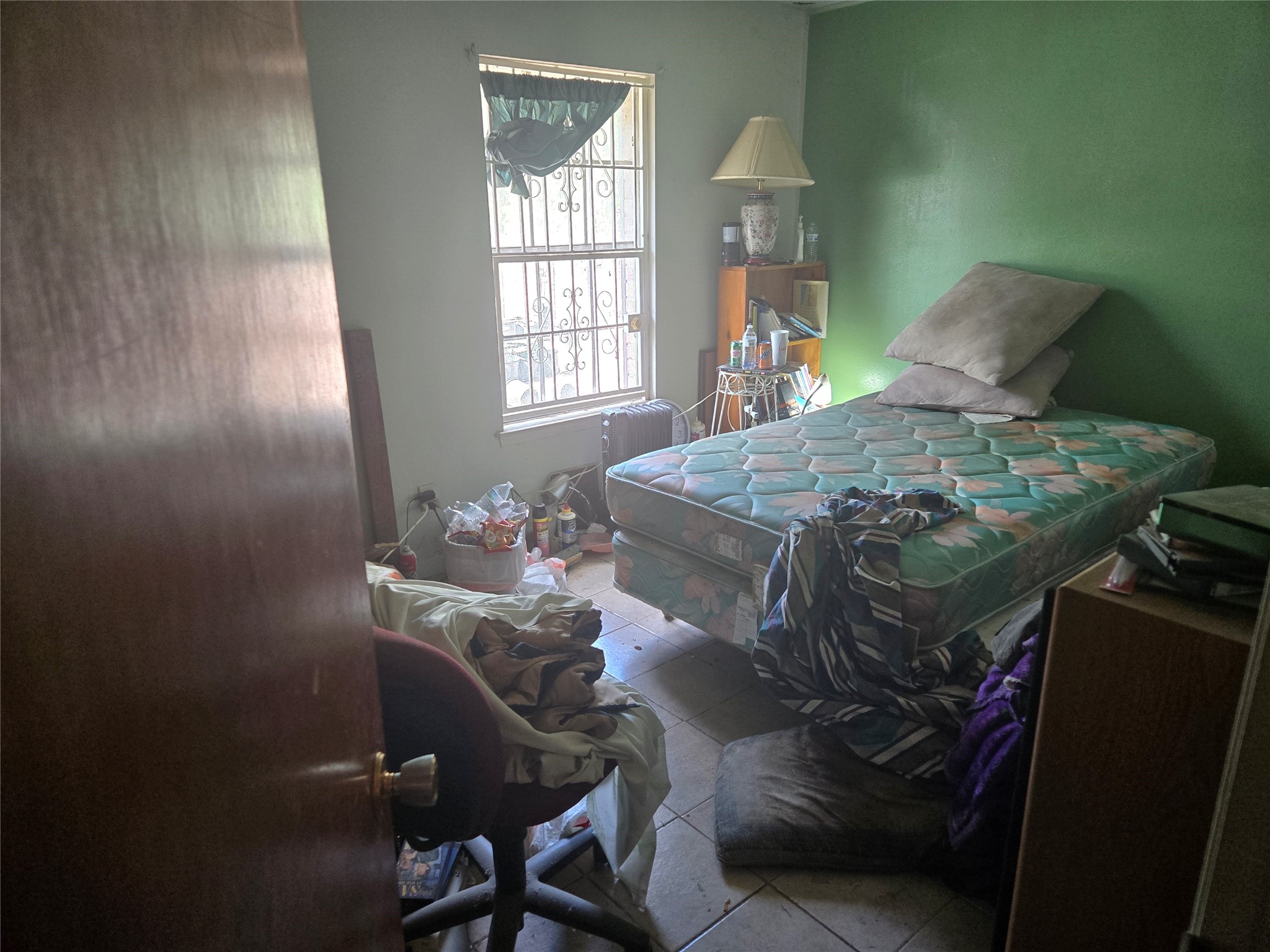 6713 Breen Drive Houston, TX 77086 - Photo 8 of 21 a bed sitting in a bedroom next to a window