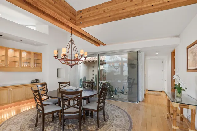 a view of a dining room with furniture and chandelier