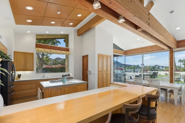 a kitchen with stainless steel appliances kitchen island granite countertop a sink and cabinets