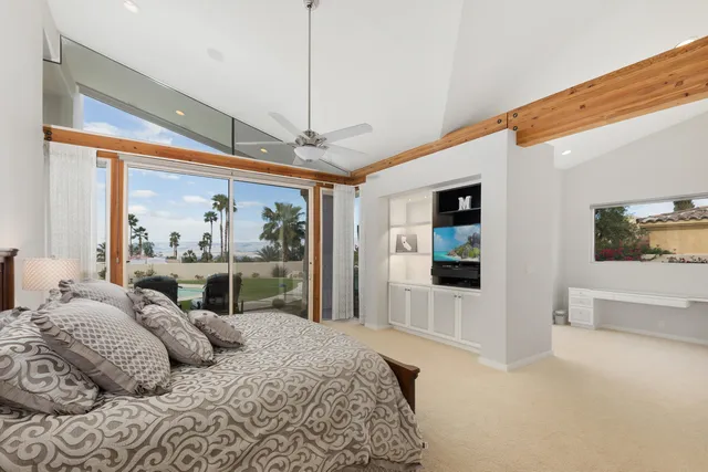 a bedroom with a large bed and a window