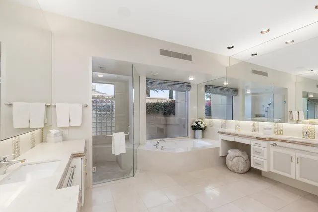 a large white kitchen with a large window