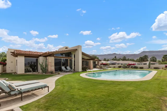 a view of a swimming pool with a yard
