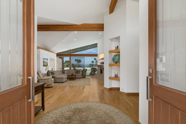 a living room with furniture large window and a view of bedroom