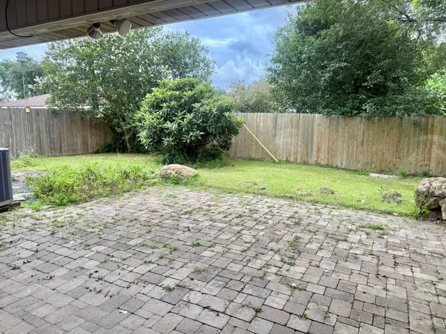 a backyard of a house with a garden and plants