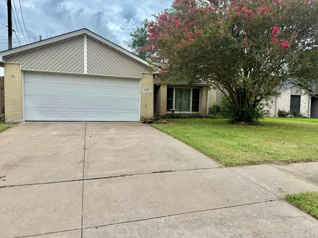 a front view of house with yard and trees