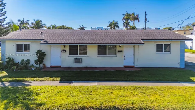 a view of a house with swimming pool and sitting area