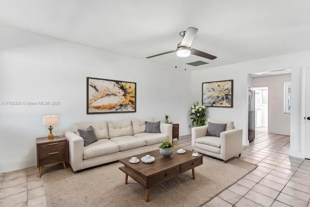 a living room with furniture a rug and a wall painting