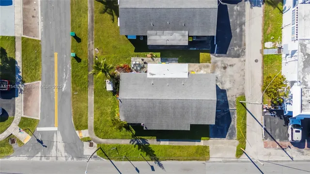 an aerial view of residential houses with outdoor space