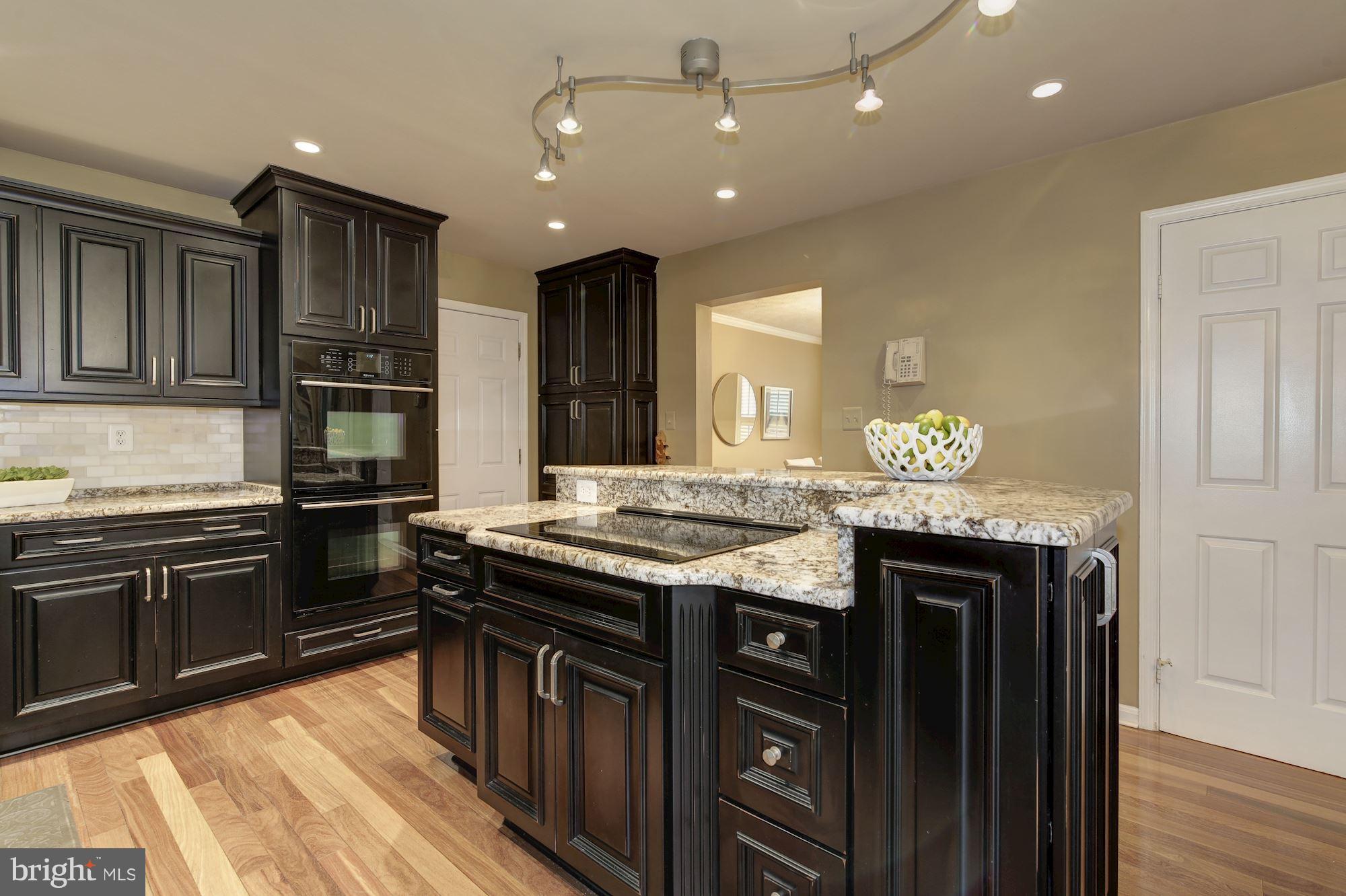 7317 Jenna Road Springfield, VA 22153 - Photo 7 of 30 Kitchen island with cooktop and tons of storage!