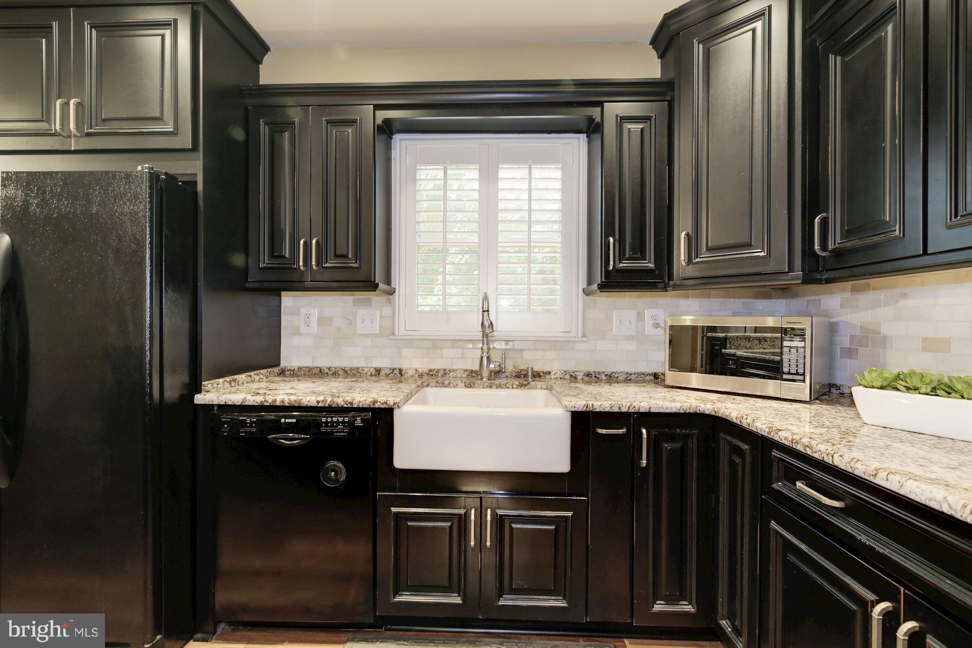 7317 Jenna Road Springfield, VA 22153 - Photo 8 of 30 Farmhouse sink overlooks deck & trees