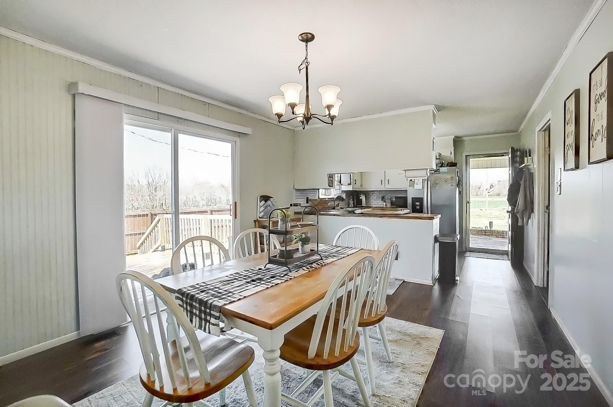 976 Pointview Lane Lincolnton, NC 28092 - Photo 14 of 43 a view of a dining room with furniture a chandelier and wooden floor