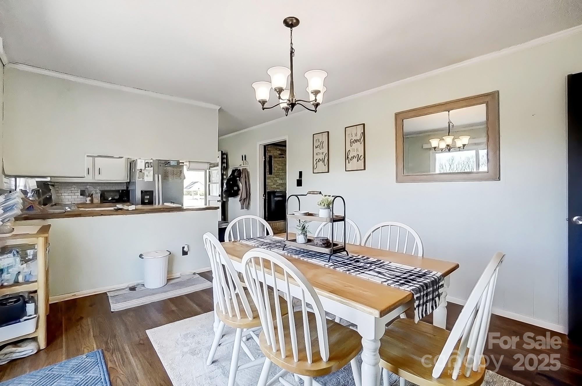 976 Pointview Lane Lincolnton, NC 28092 - Photo 15 of 43 a view of a dining room with furniture a chandelier and wooden floor