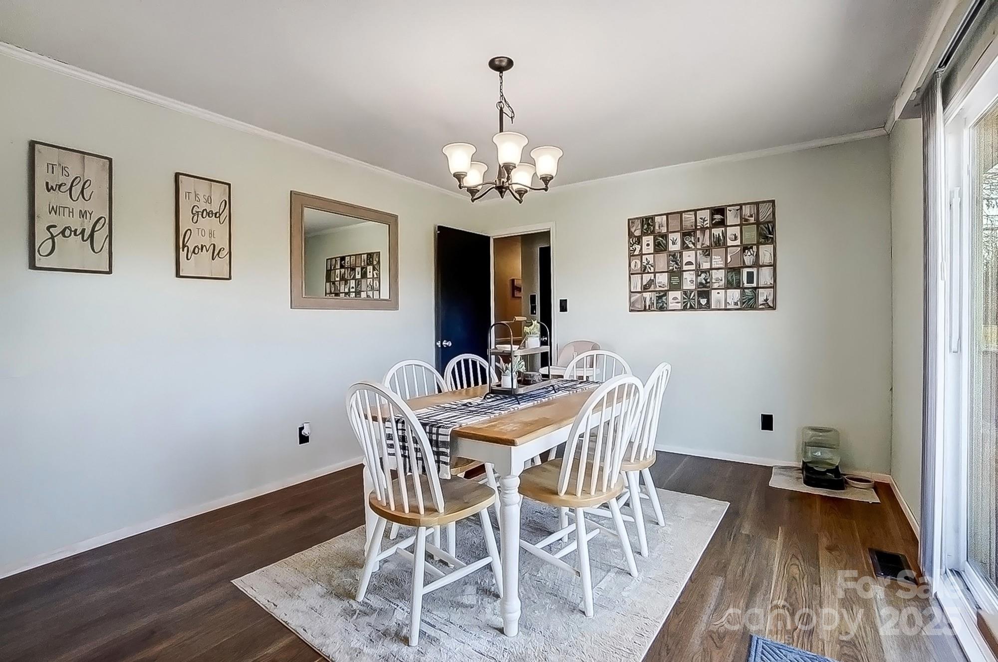 976 Pointview Lane Lincolnton, NC 28092 - Photo 16 of 43 a view of a dining room with furniture wooden floor and a chandelier