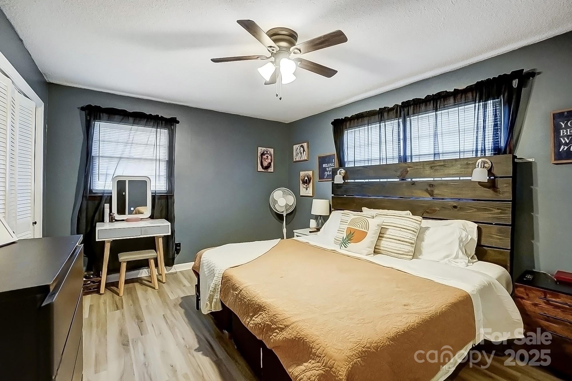 976 Pointview Lane Lincolnton, NC 28092 - Photo 21 of 43 a bedroom with a bed and a table with wooden floor