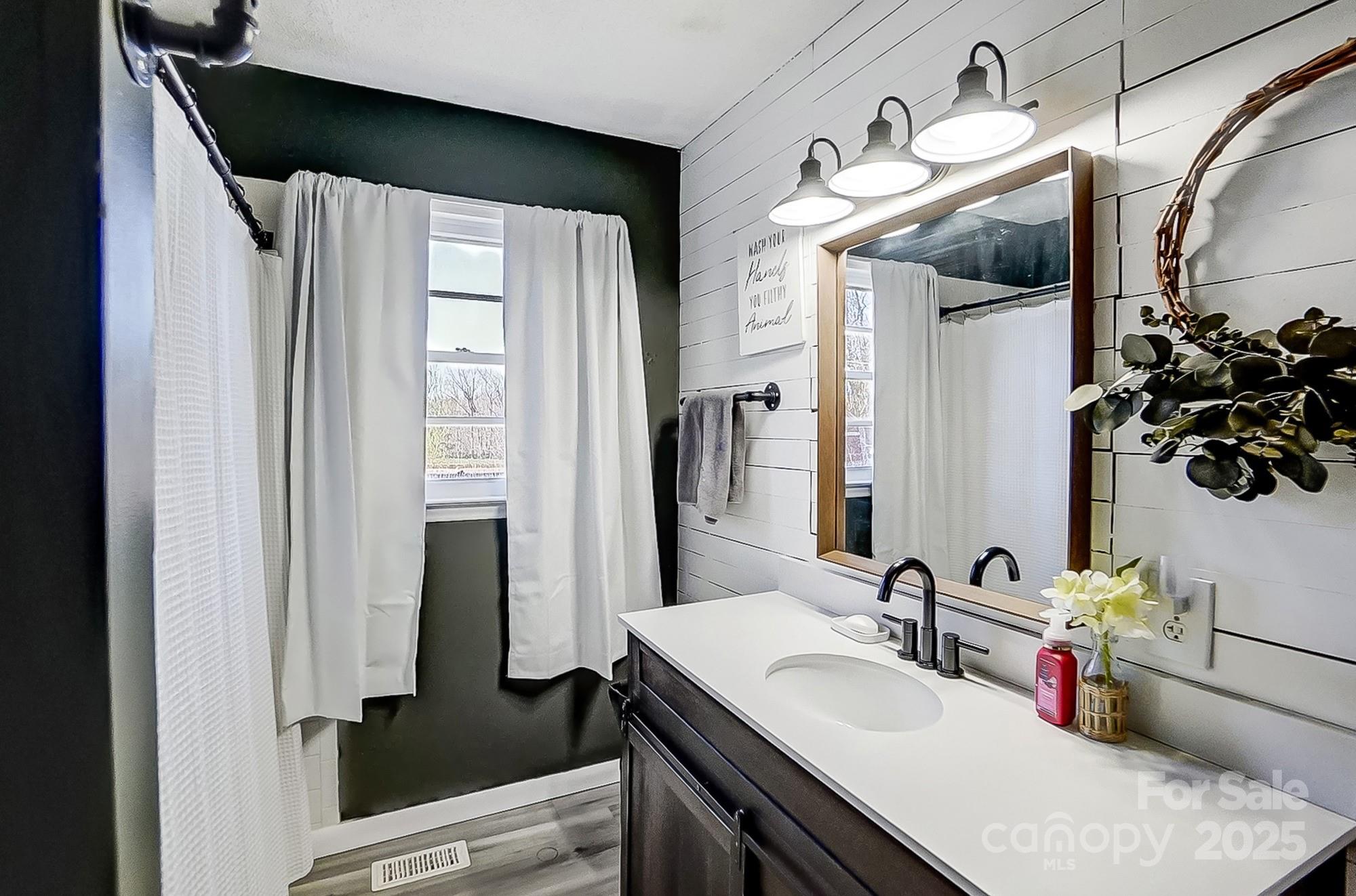976 Pointview Lane Lincolnton, NC 28092 - Photo 28 of 43 a bathroom with a granite countertop sink a mirror and vanity