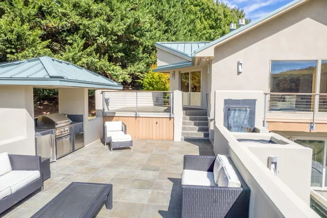 a living room with furniture and a baby crib