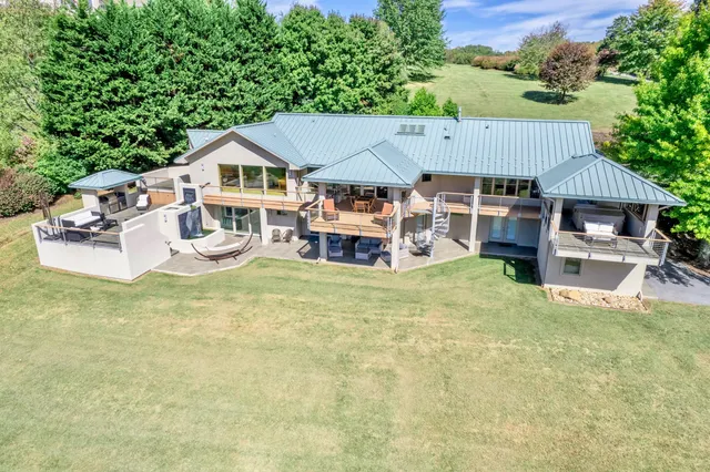 a large kitchen with kitchen island granite countertop a sink and a refrigerator