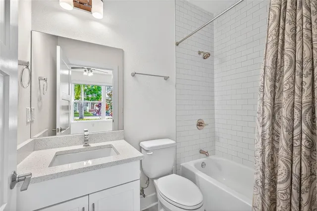 a kitchen with kitchen island a counter top space a refrigerator and cabinets