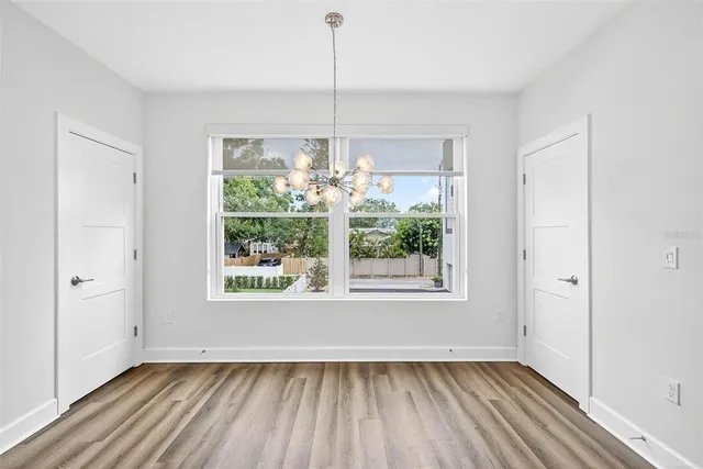 a living room with kitchen island granite countertop furniture and a chandelier