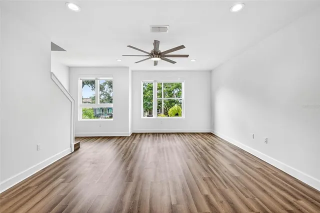 wooden floor in an empty room with a window