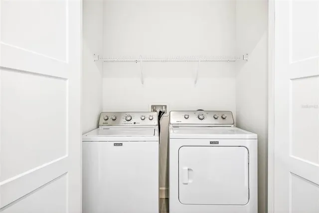 a view of an empty room with a ceiling fan