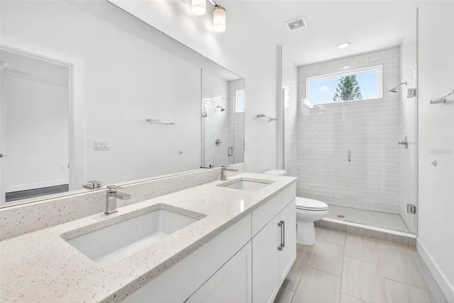 a view of a hallway with wooden floor and entryway