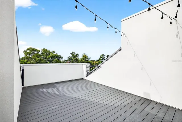 a view of a house with potted plants and more windows
