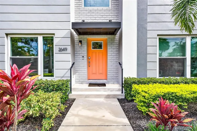 a front view of a house with a garden