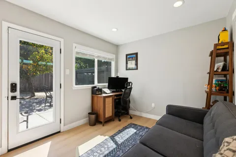 a livingroom with workspace and a window