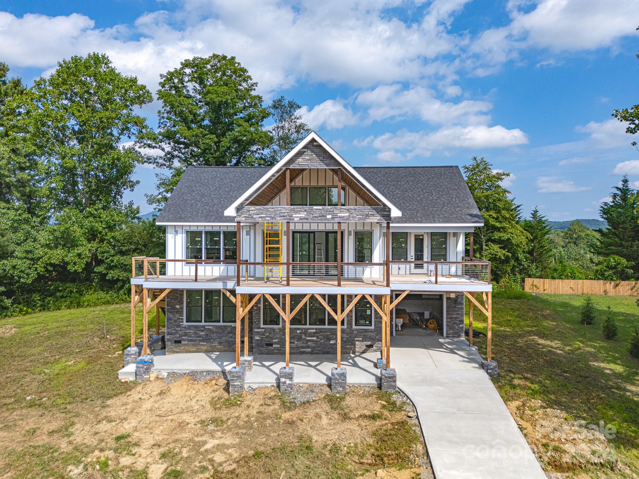 171 Tatham Road Hendersonville, NC 28792 - Photo 1 of 19 a front view of a house with garden
