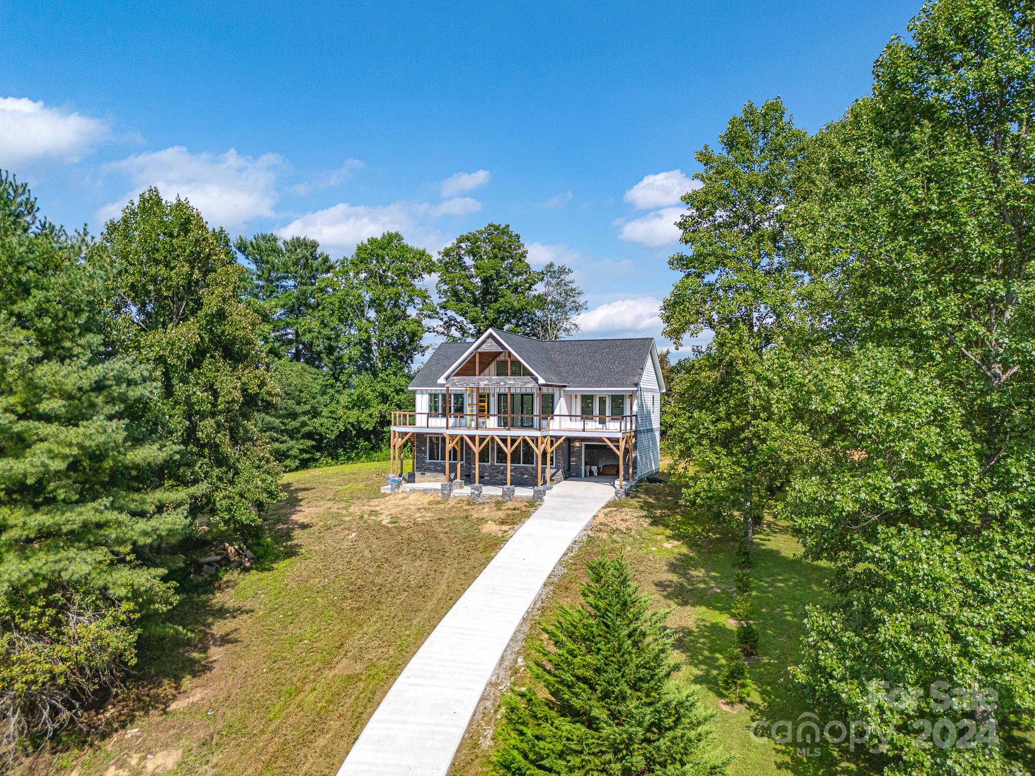 171 Tatham Road Hendersonville, NC 28792 - Photo 16 of 19 a view of a house with a big yard and large trees