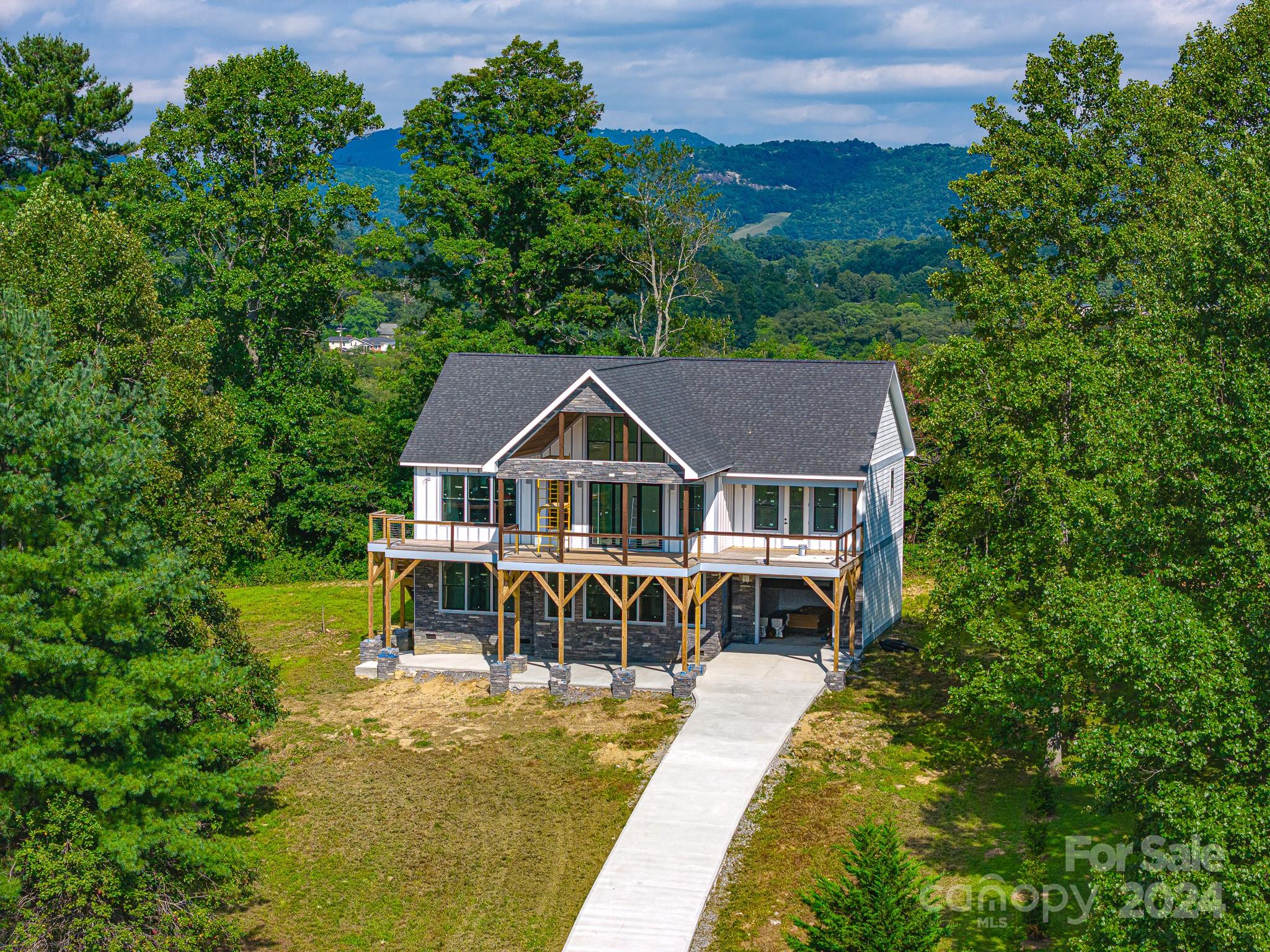 171 Tatham Road Hendersonville, NC 28792 - Photo 17 of 19 a front view of a house with a garden