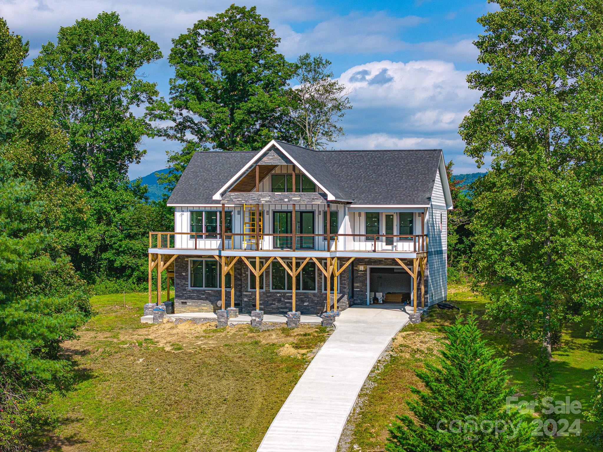 171 Tatham Road Hendersonville, NC 28792 - Photo 18 of 19 a front view of a house with a yard table and chairs