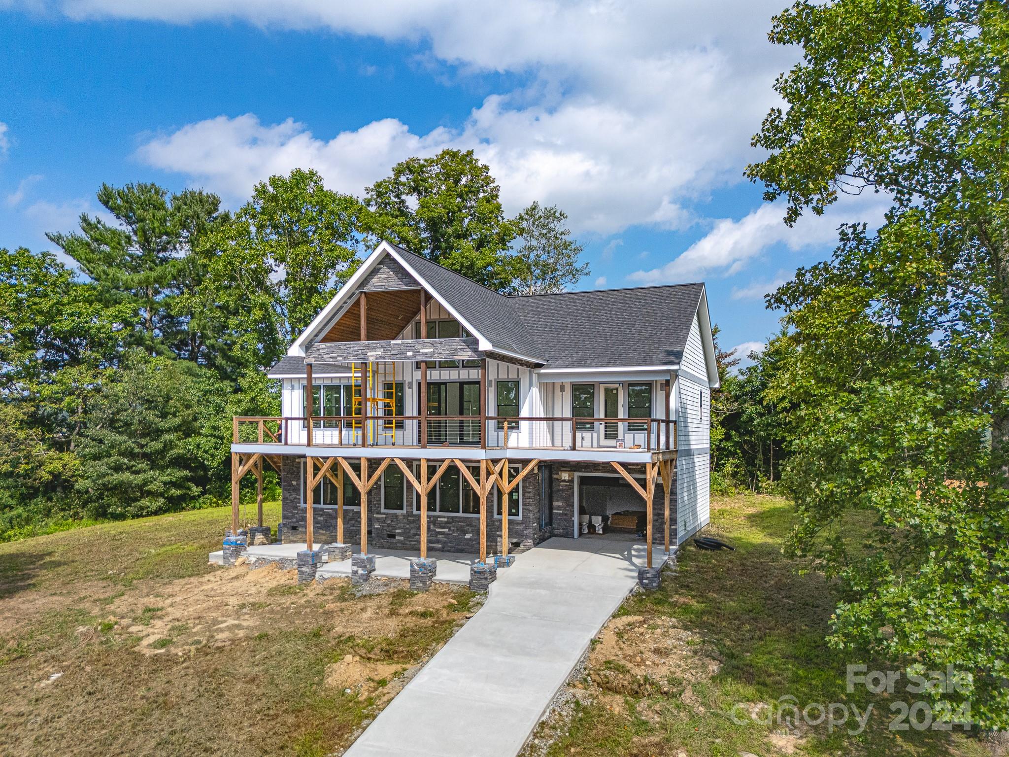 171 Tatham Road Hendersonville, NC 28792 - Photo 3 of 19 a front view of a house with garden