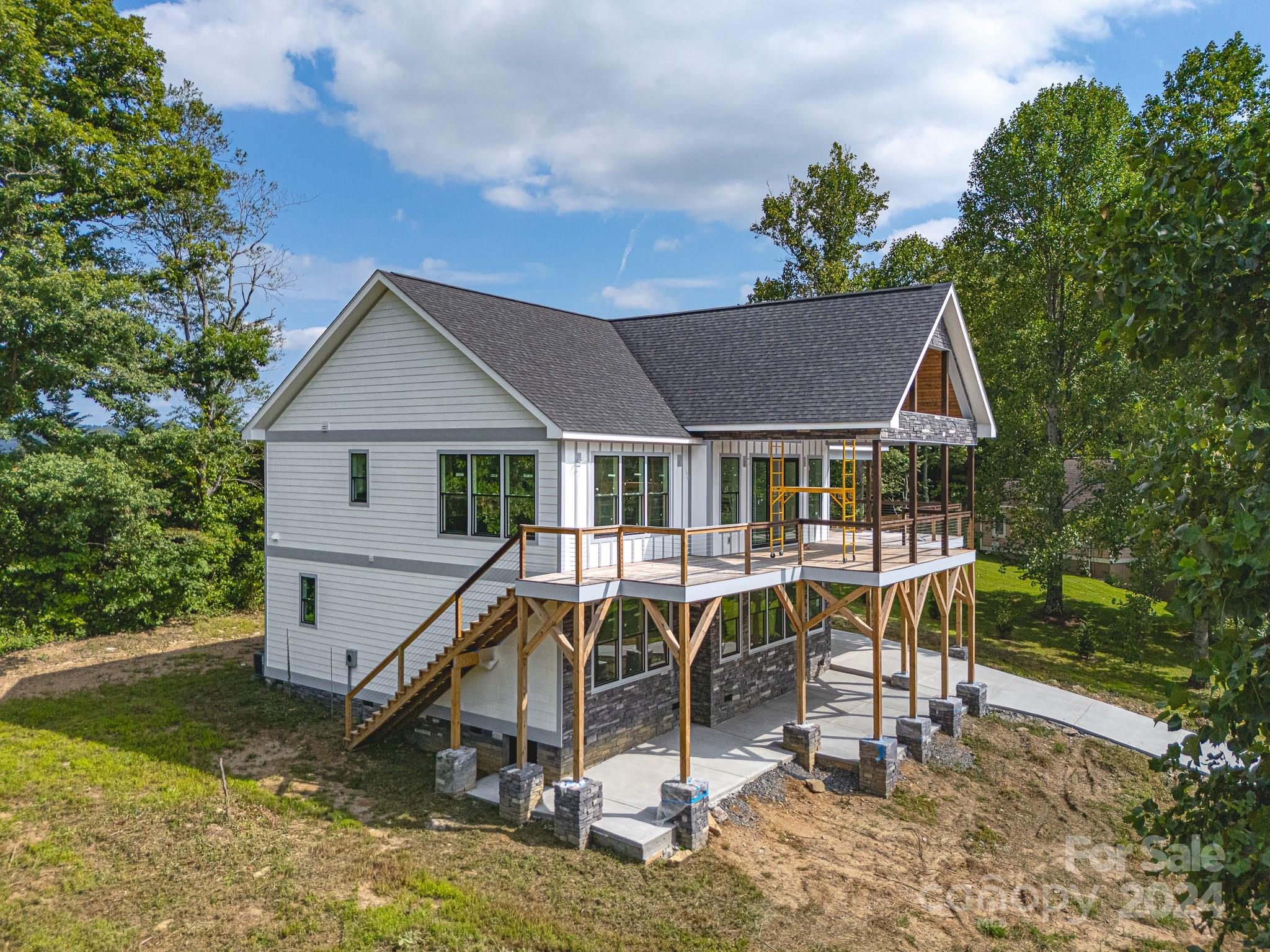 171 Tatham Road Hendersonville, NC 28792 - Photo 4 of 19 a view of house with swimming pool and sitting area