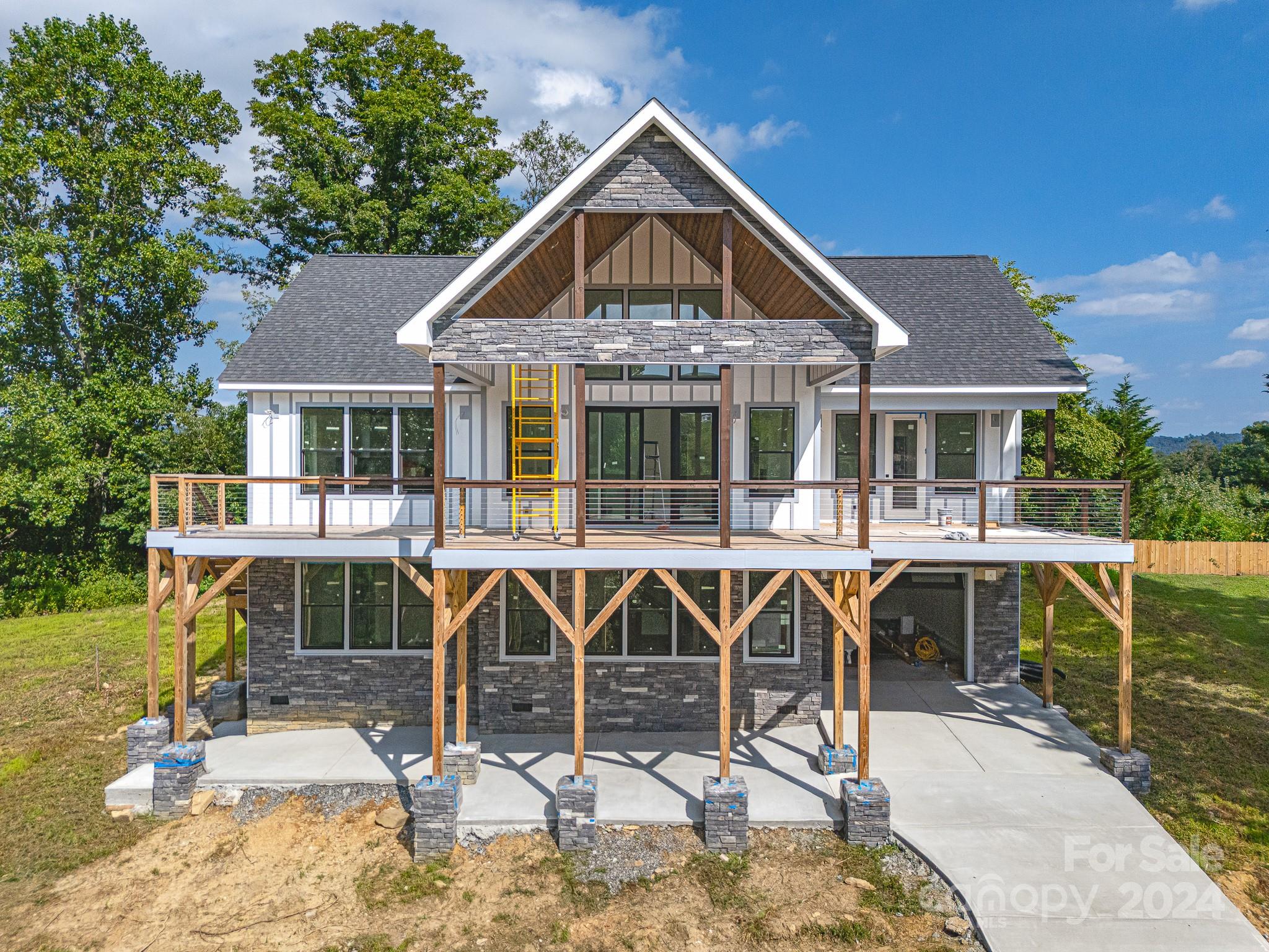 171 Tatham Road Hendersonville, NC 28792 - Photo 8 of 19 a view of a house with backyard porch and sitting area