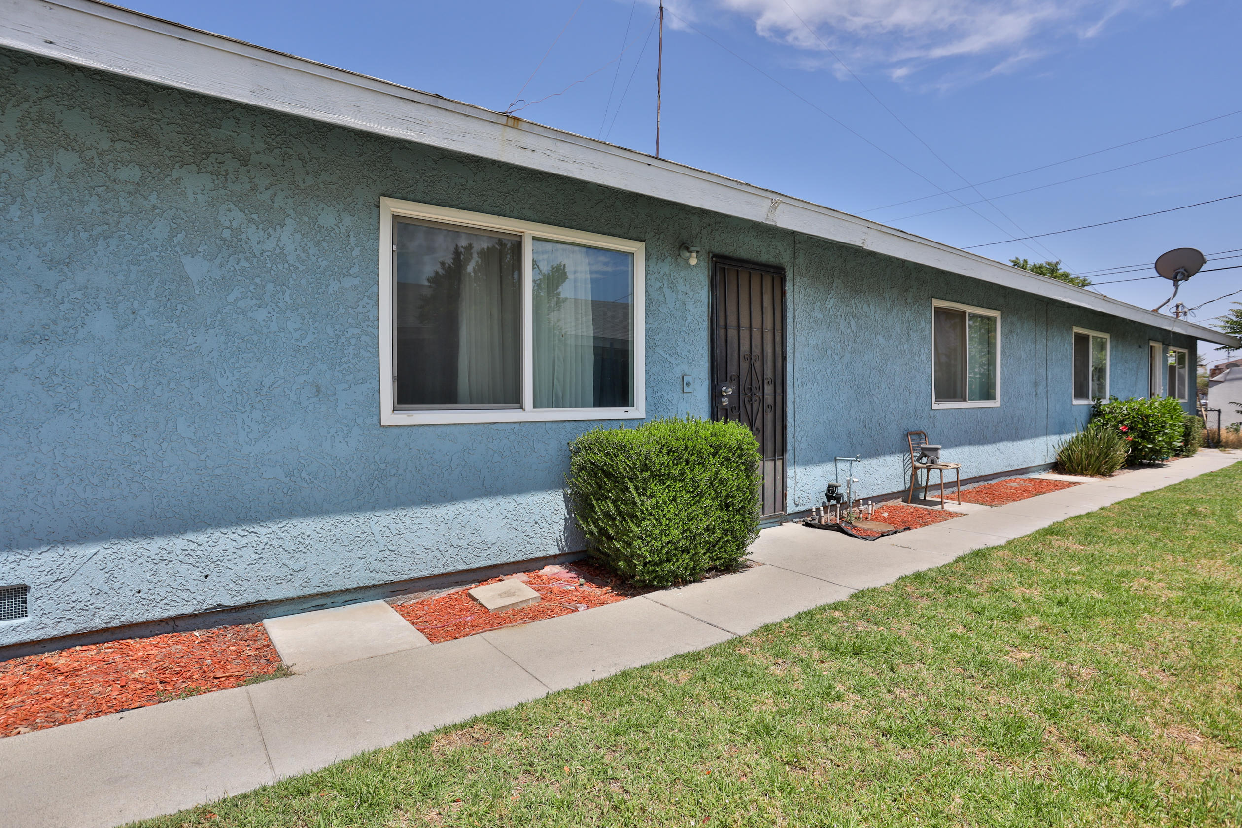 464 Riverside Avenue Rialto, CA 92376 - Photo 1 of 33 a front view of a house with porch and chairs