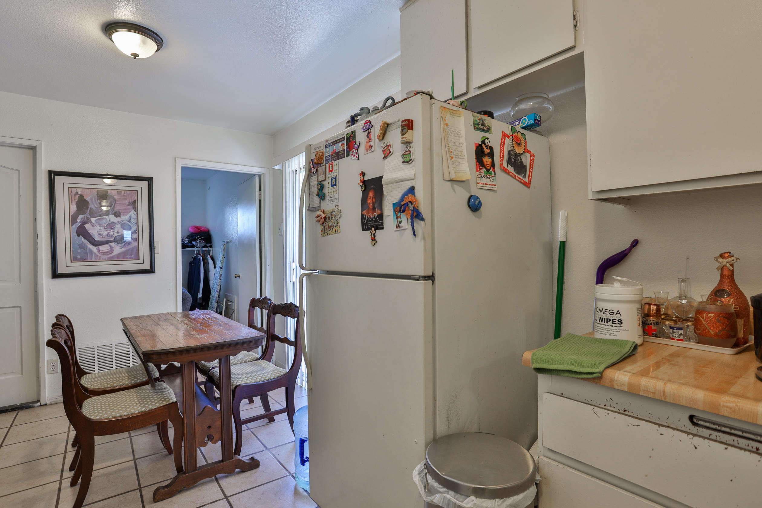 464 Riverside Avenue Rialto, CA 92376 - Photo 12 of 33 a white kitchen with a refrigerator and a table