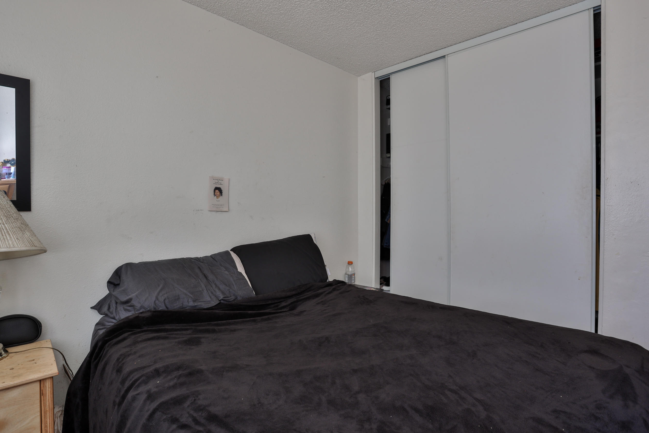 464 Riverside Avenue Rialto, CA 92376 - Photo 14 of 33 a bedroom with a bed and a window