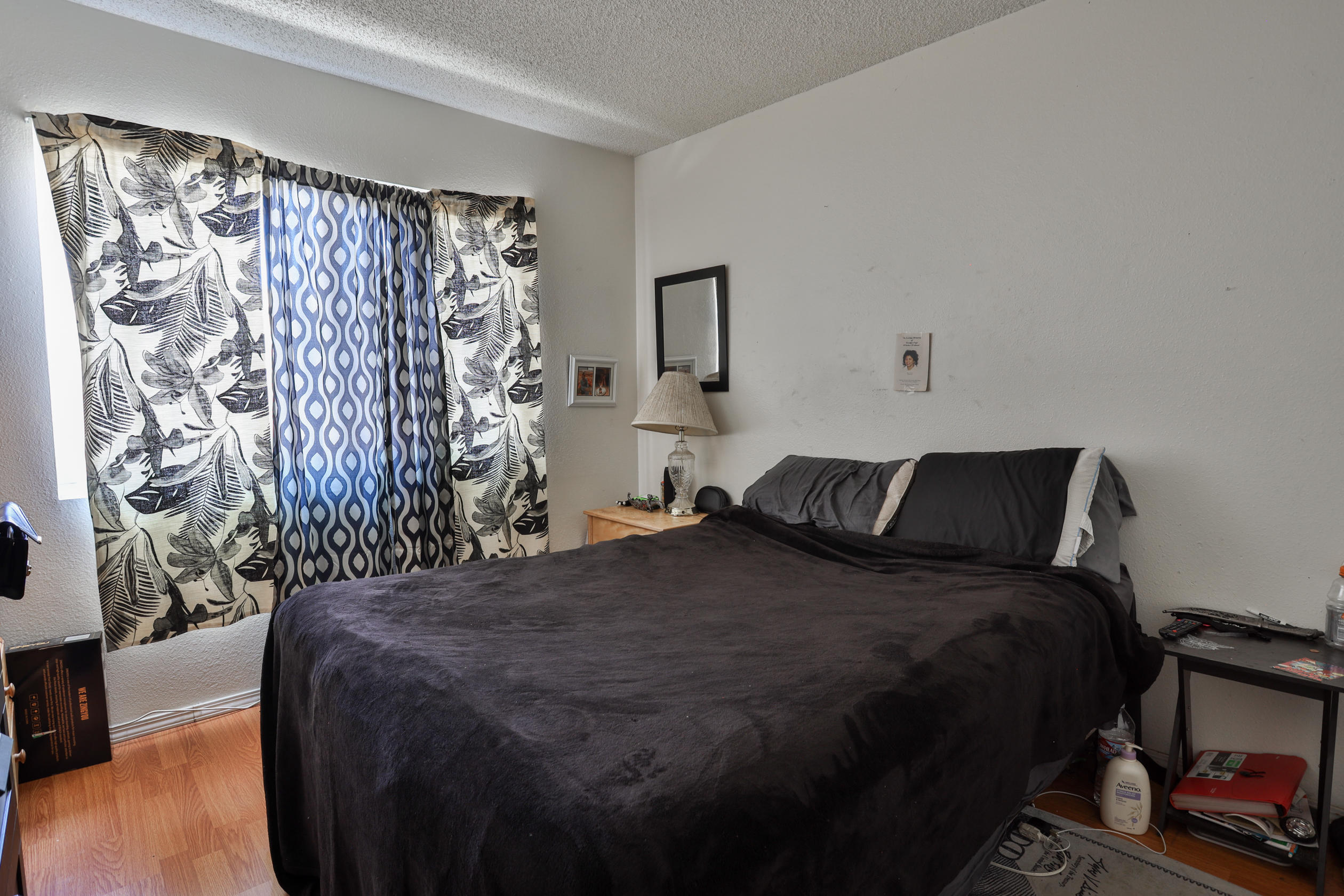 464 Riverside Avenue Rialto, CA 92376 - Photo 15 of 33 a bed sitting in a bedroom next to a window and a chair