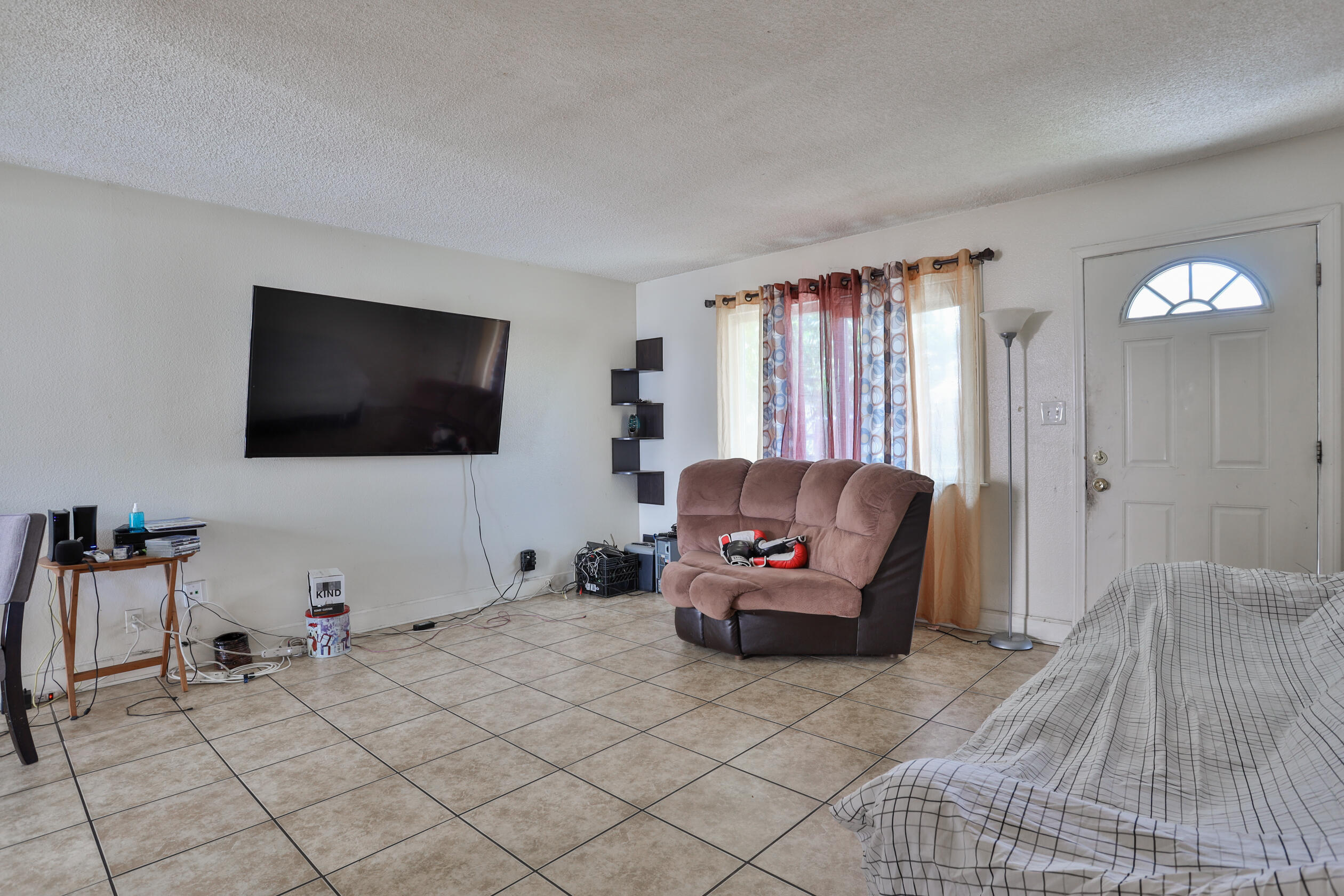 464 Riverside Avenue Rialto, CA 92376 - Photo 19 of 33 a living room with furniture and a flat screen tv
