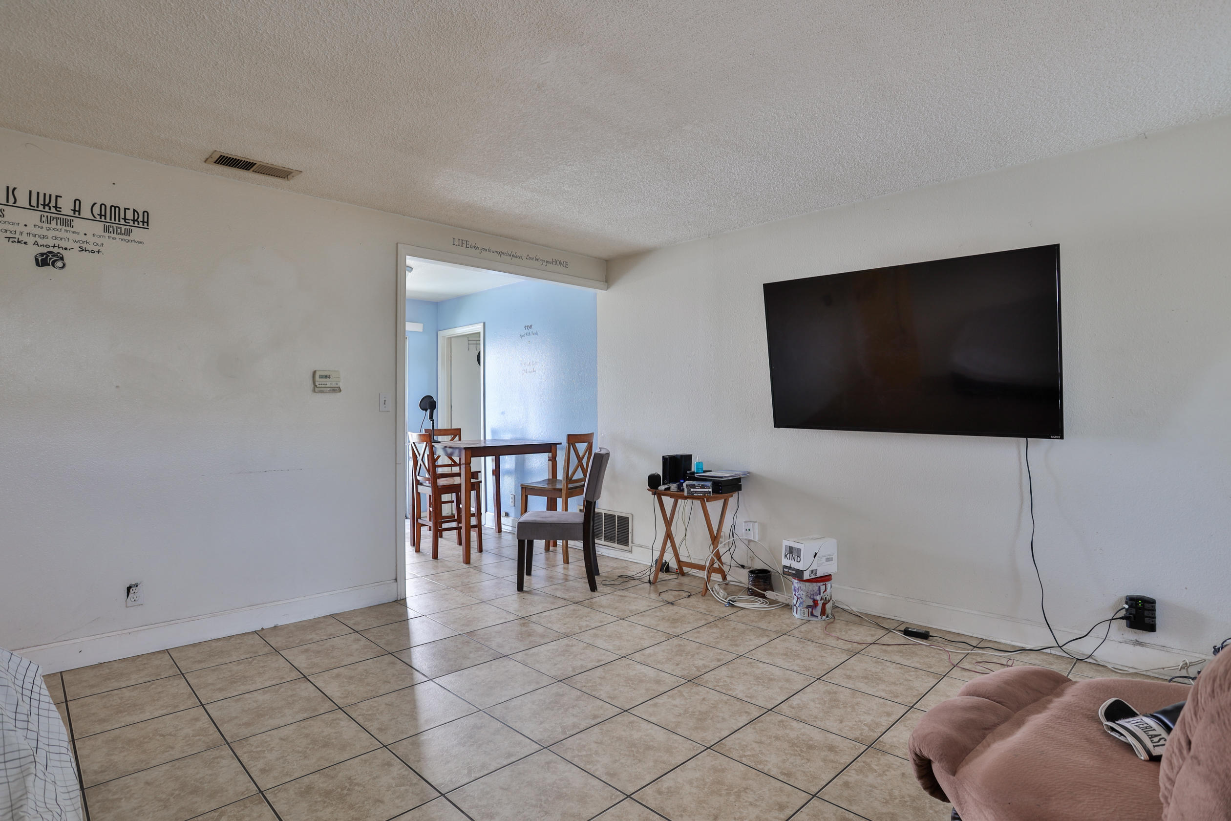 464 Riverside Avenue Rialto, CA 92376 - Photo 22 of 33 a living room with furniture and a flat screen tv
