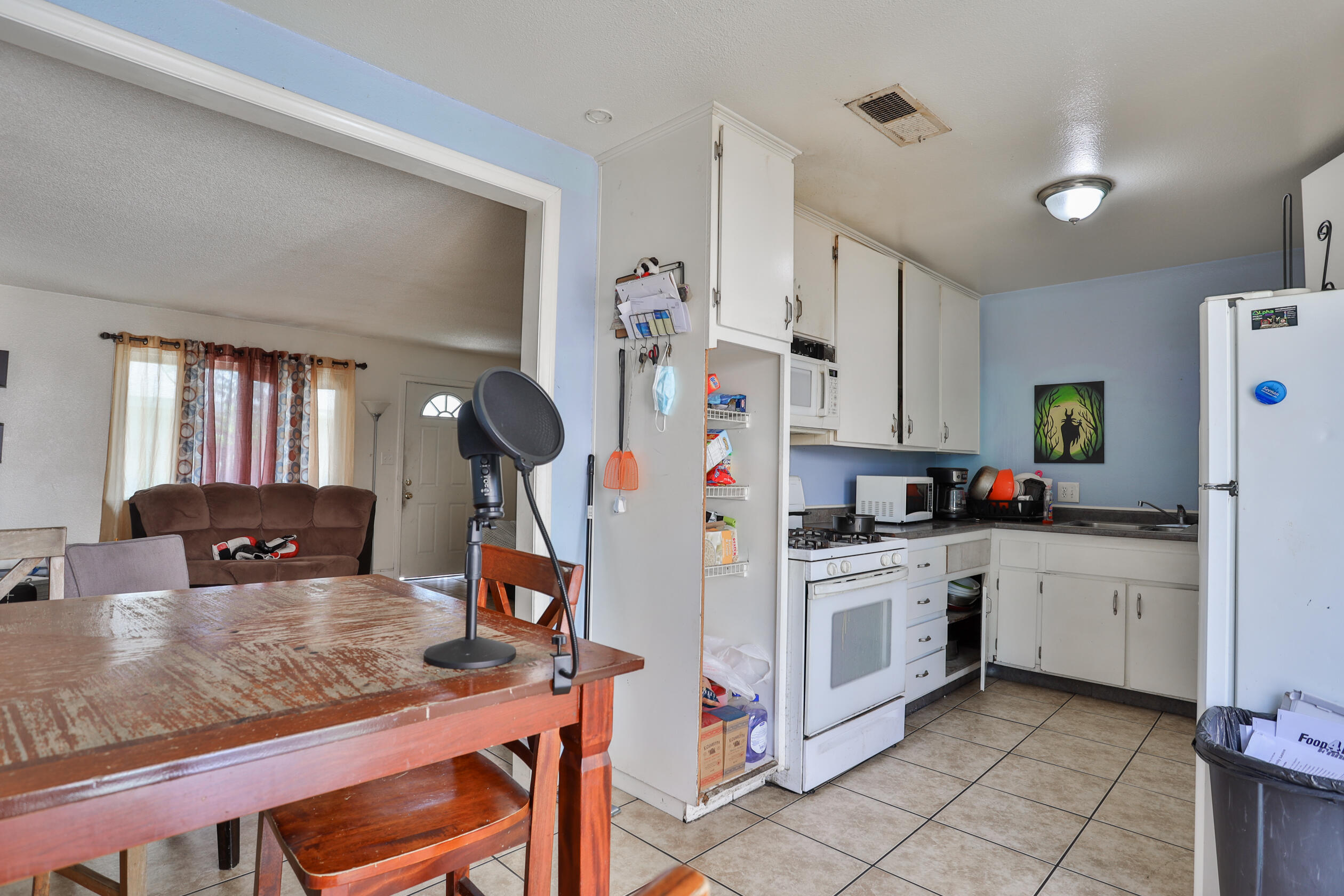 464 Riverside Avenue Rialto, CA 92376 - Photo 23 of 33 a kitchen with stainless steel appliances kitchen island granite countertop a stove a sink and a refrigerator