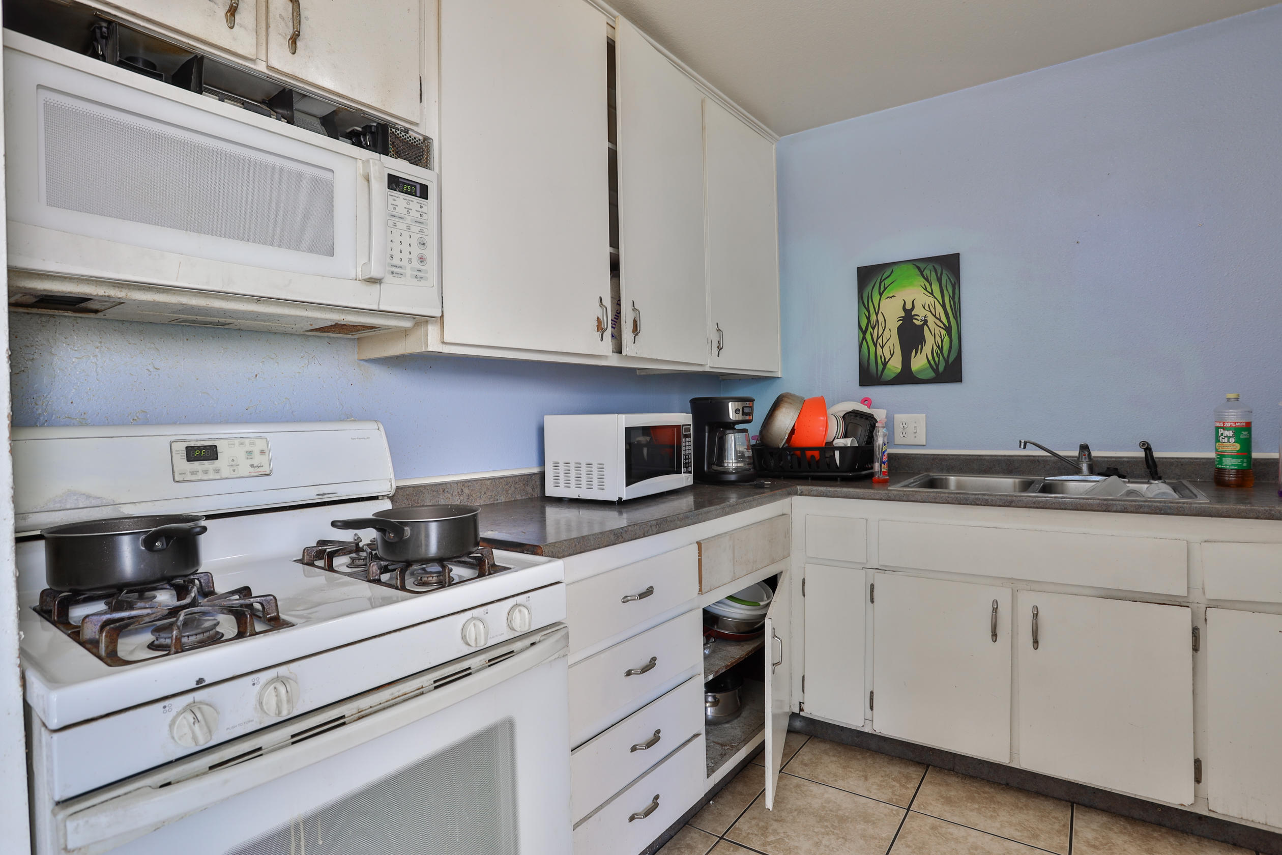 464 Riverside Avenue Rialto, CA 92376 - Photo 24 of 33 a kitchen with white cabinets and appliances