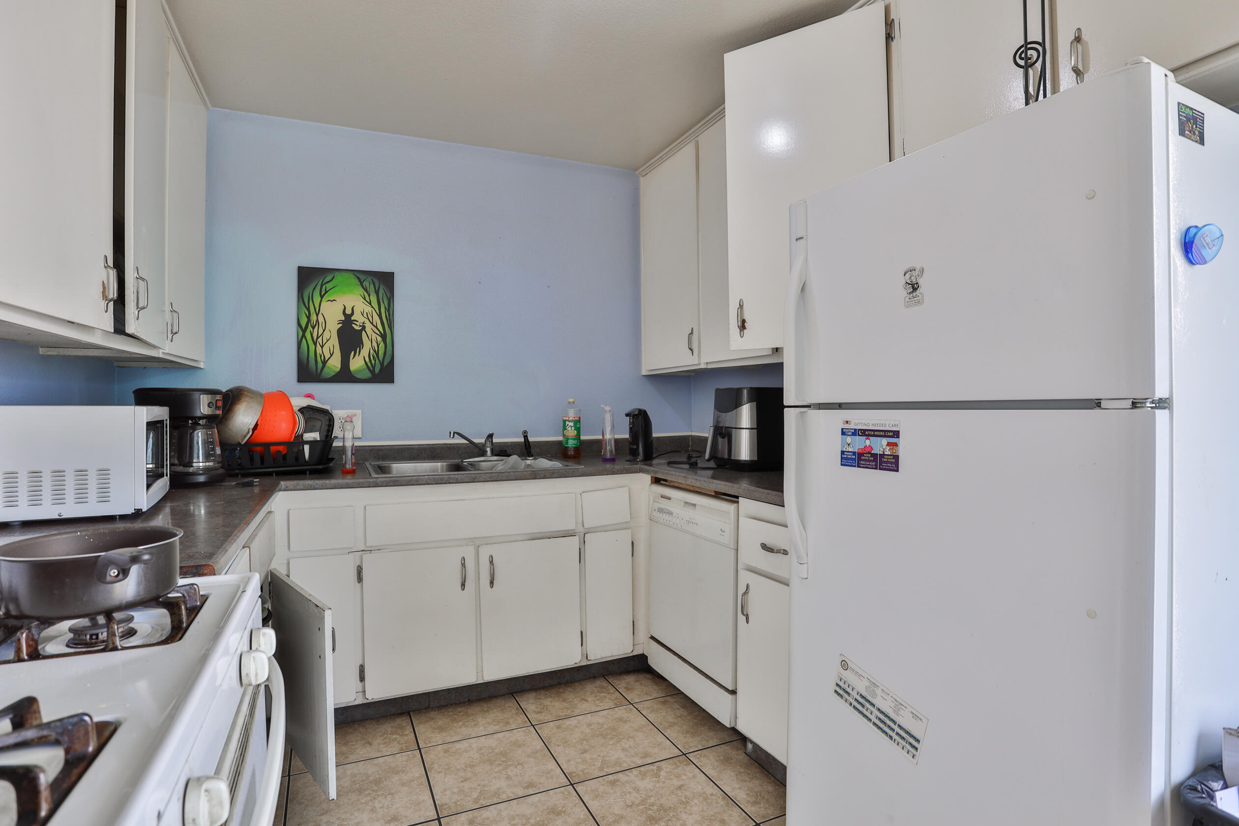 464 Riverside Avenue Rialto, CA 92376 - Photo 25 of 33 a kitchen with white cabinets and white appliances