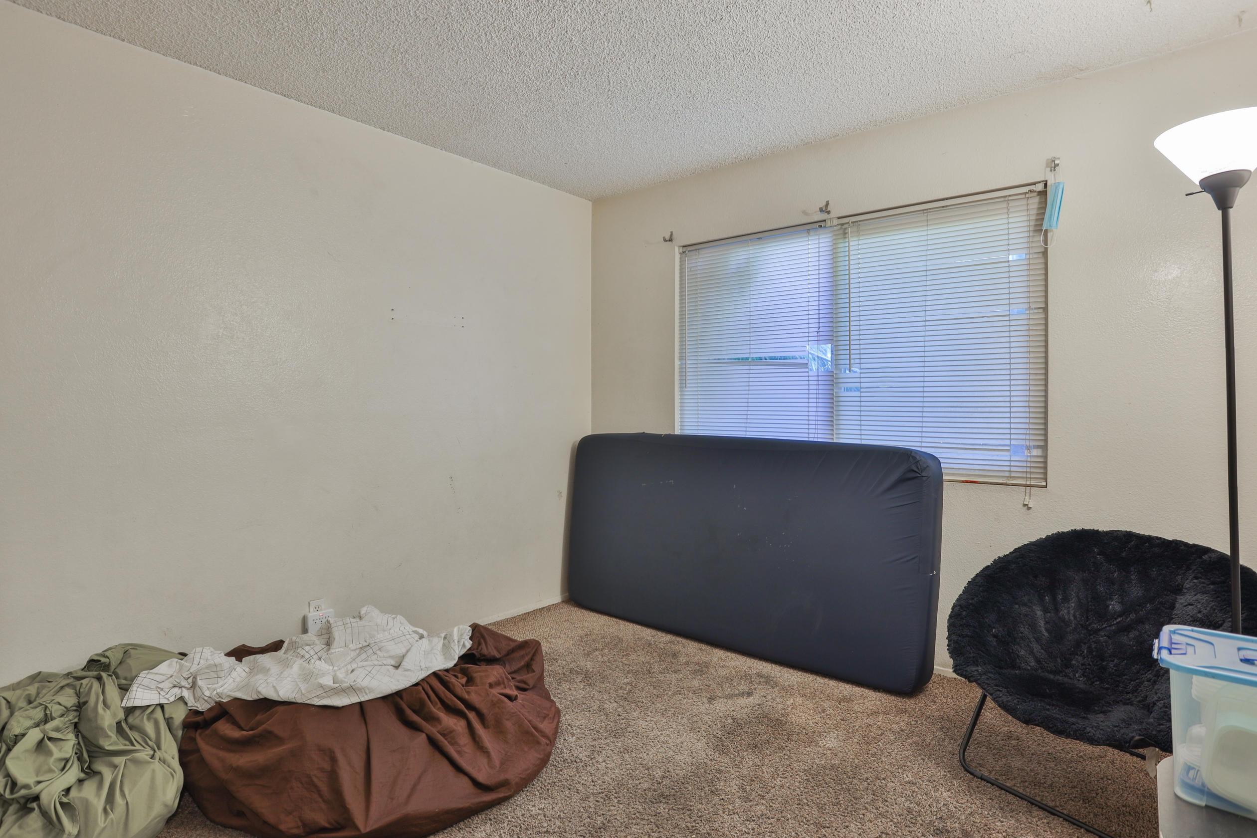 464 Riverside Avenue Rialto, CA 92376 - Photo 32 of 33 a bedroom with a bed and a chair