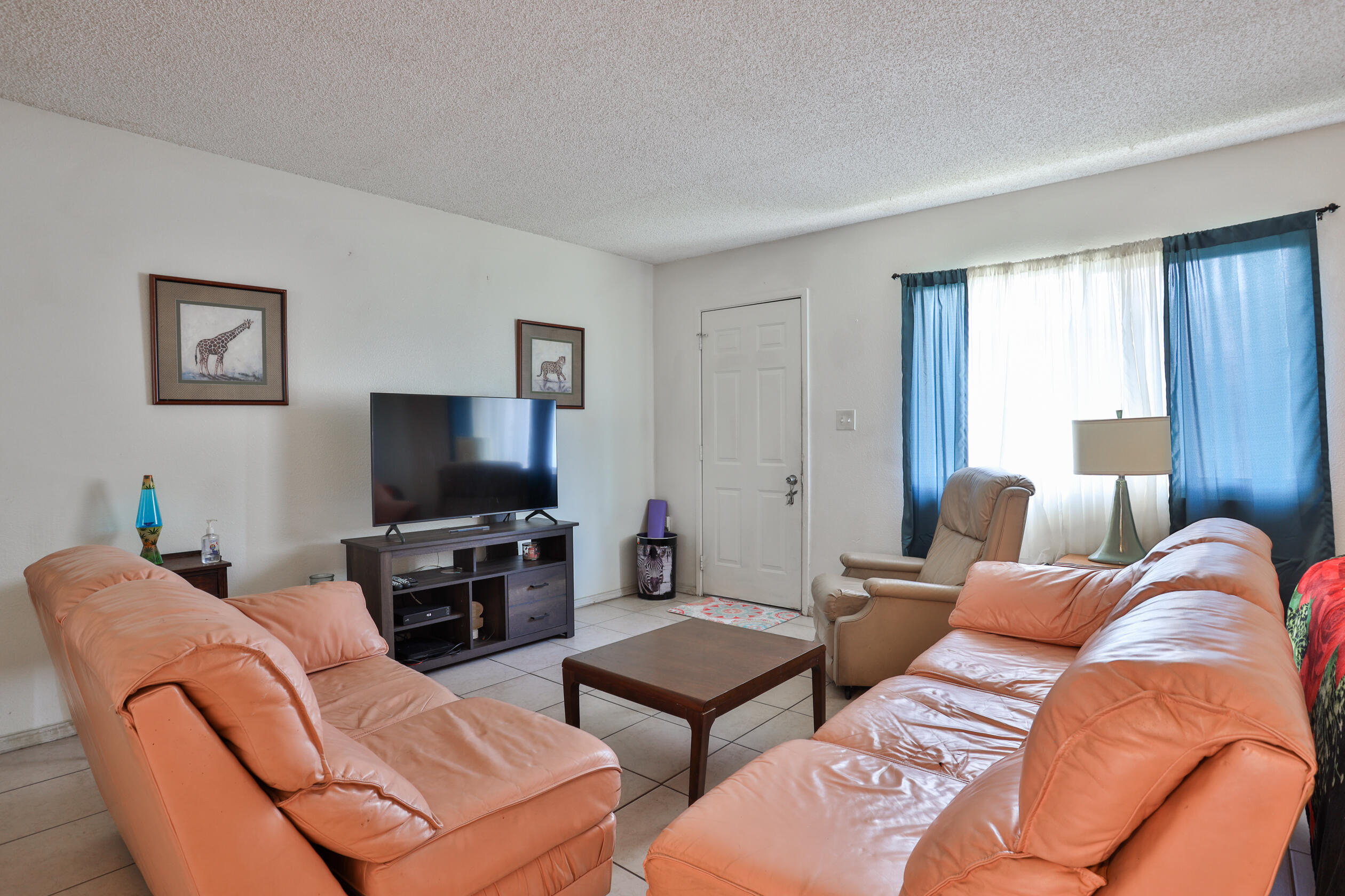 464 Riverside Avenue Rialto, CA 92376 - Photo 5 of 33 a living room with furniture and a flat screen tv
